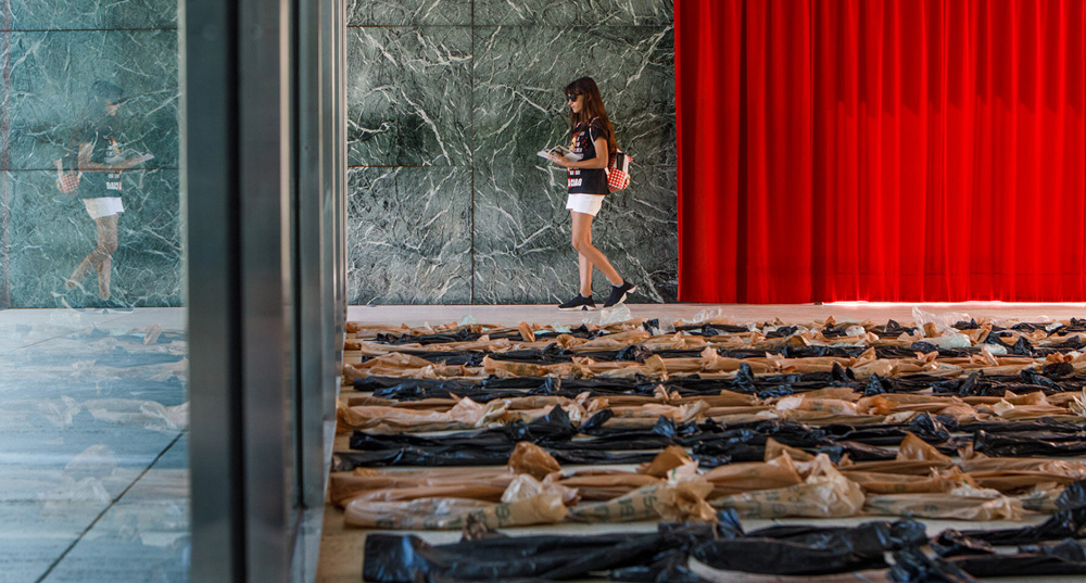 Endless plastic bags fill mies van der rohe`s barcelona pavilion to spotlight the cost of money