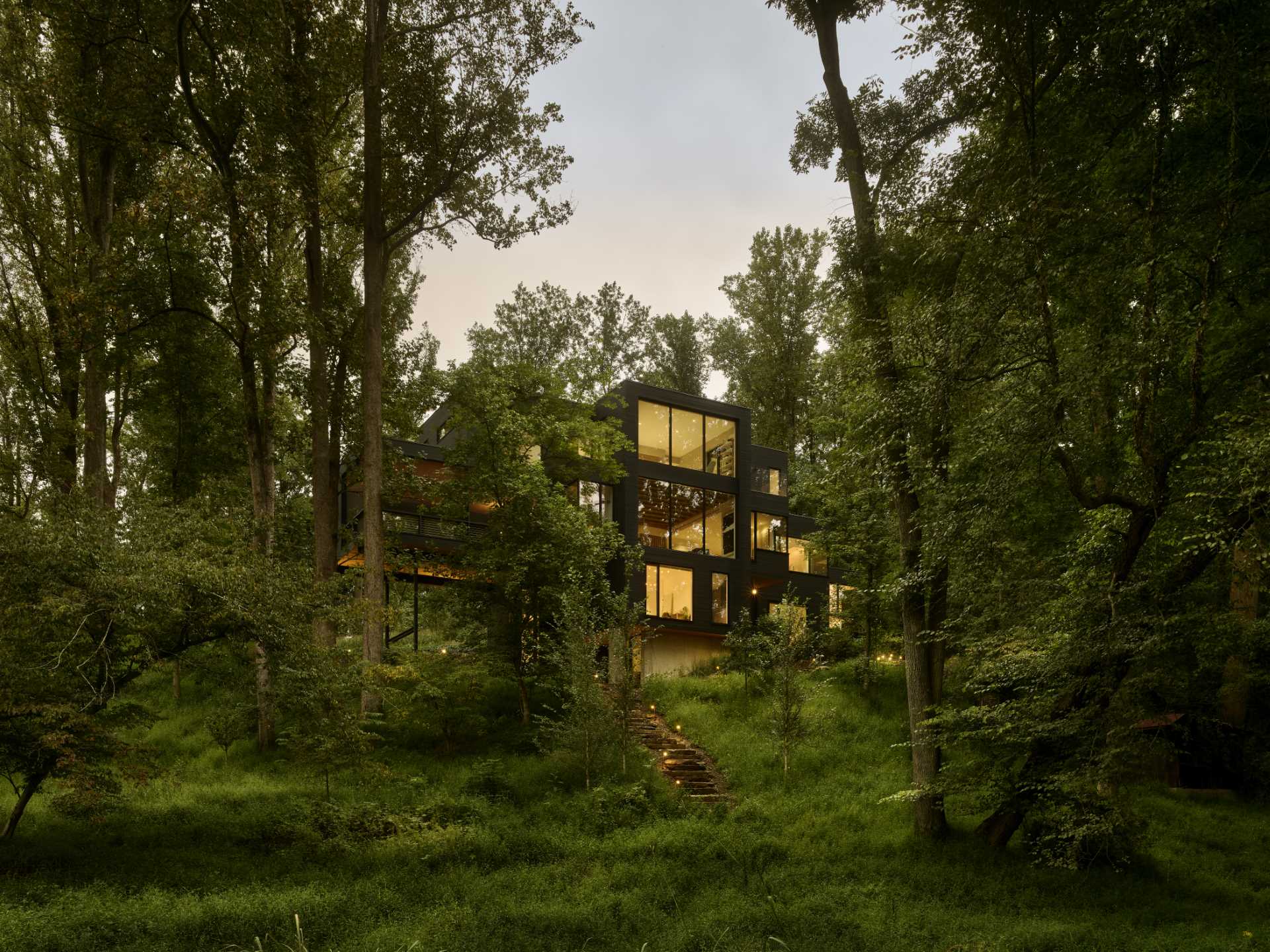 A Dark Exterior Helps To Hide This Modern Home In The Forest