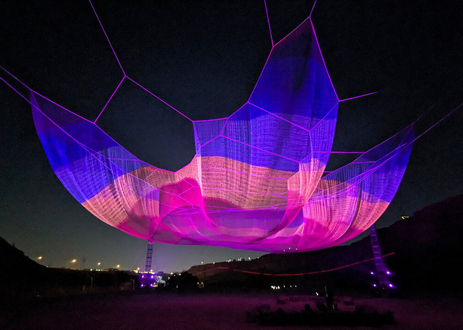 Janet echelman`s braided earthtime sculpture in riyadh is a visual echo of tsunami ripples