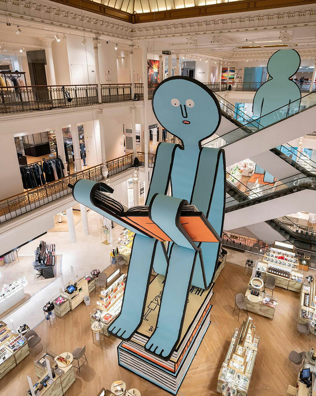 Jean jullien`s paper people land at le bon marché for book-themed exhibition in paris