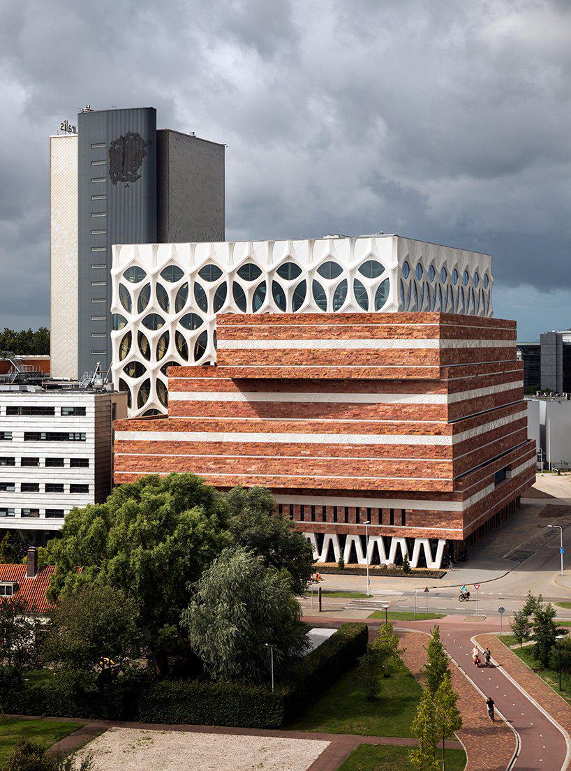 iris van herpen wraps neutelings riedijk-designed naturalis in silky concrete geological frieze