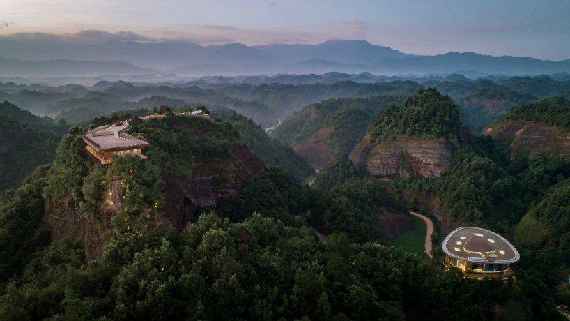 mountaintop hotel in china offers views across a landscape of rivers, forests, and hills