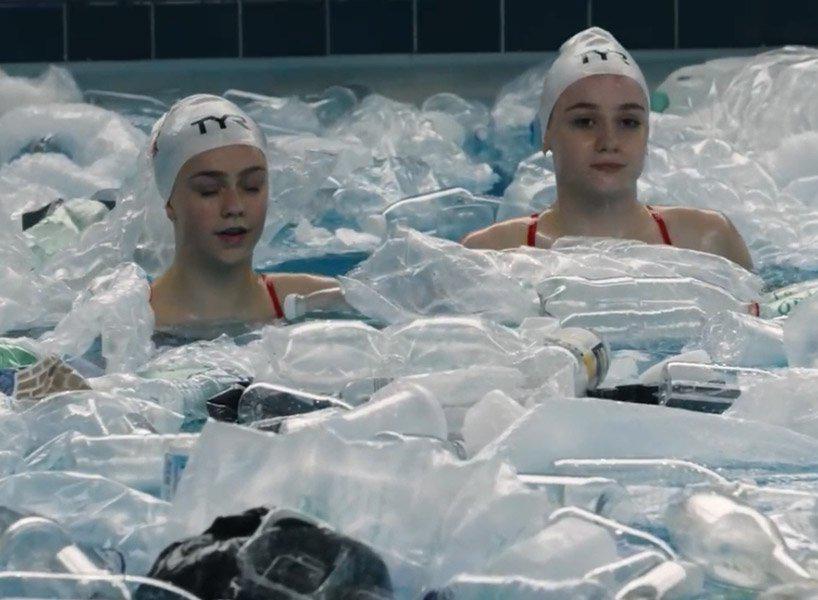 synchronized swimmers in a pool full of rubbish raise awareness of plastic pollution