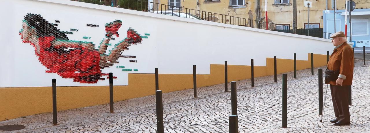 cross-stitch street art: portugese artist combines digital and analog design