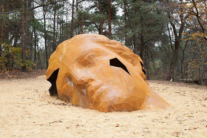 gijs van vaerenberghs giant sculpture emerges from a belgian dune