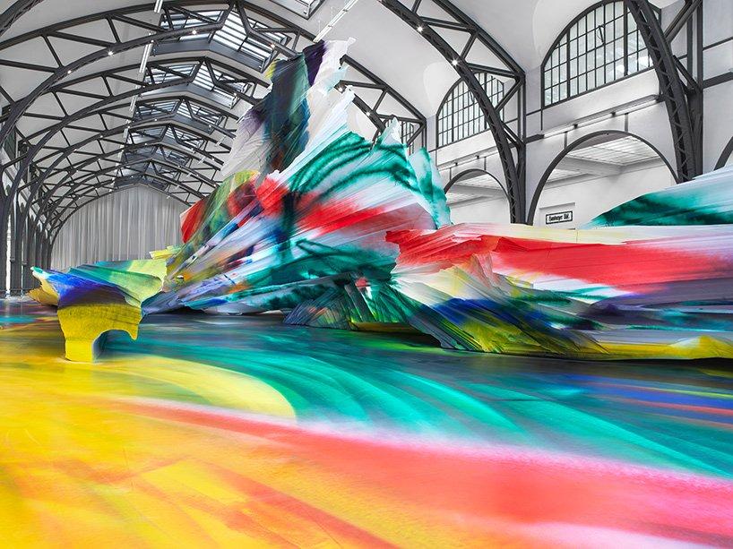 katharina grosse immerses former railway building in explosive kaleidoscopic painting