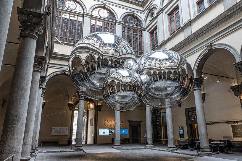 tomas saraceno brings illuminated spiderwebs reflective spheres and more to palazzo strozzi