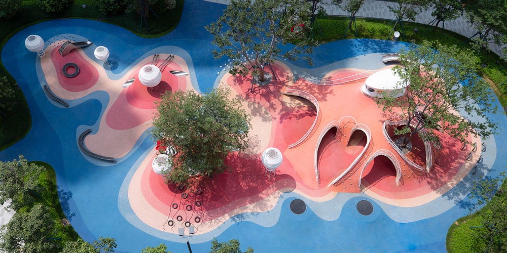 Red dunes playtopia in china embraces undulating landscape for children`s activities