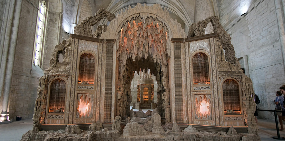 Eva jospin weaves enchanting cardboard landscape into palais de papes` gothic architecture