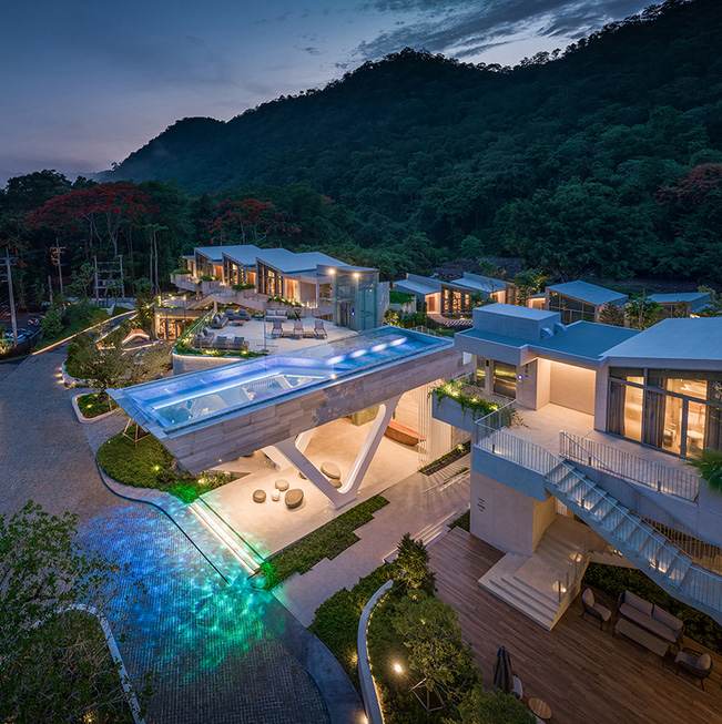 Cantilevered transparent pool hovers above hotel complex in thailand